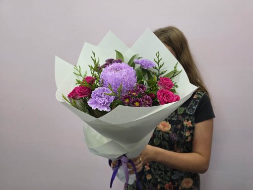 Holding Mauve Posy of Flowers